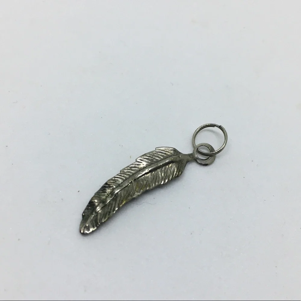 Feather shaped silver tone pendant charm